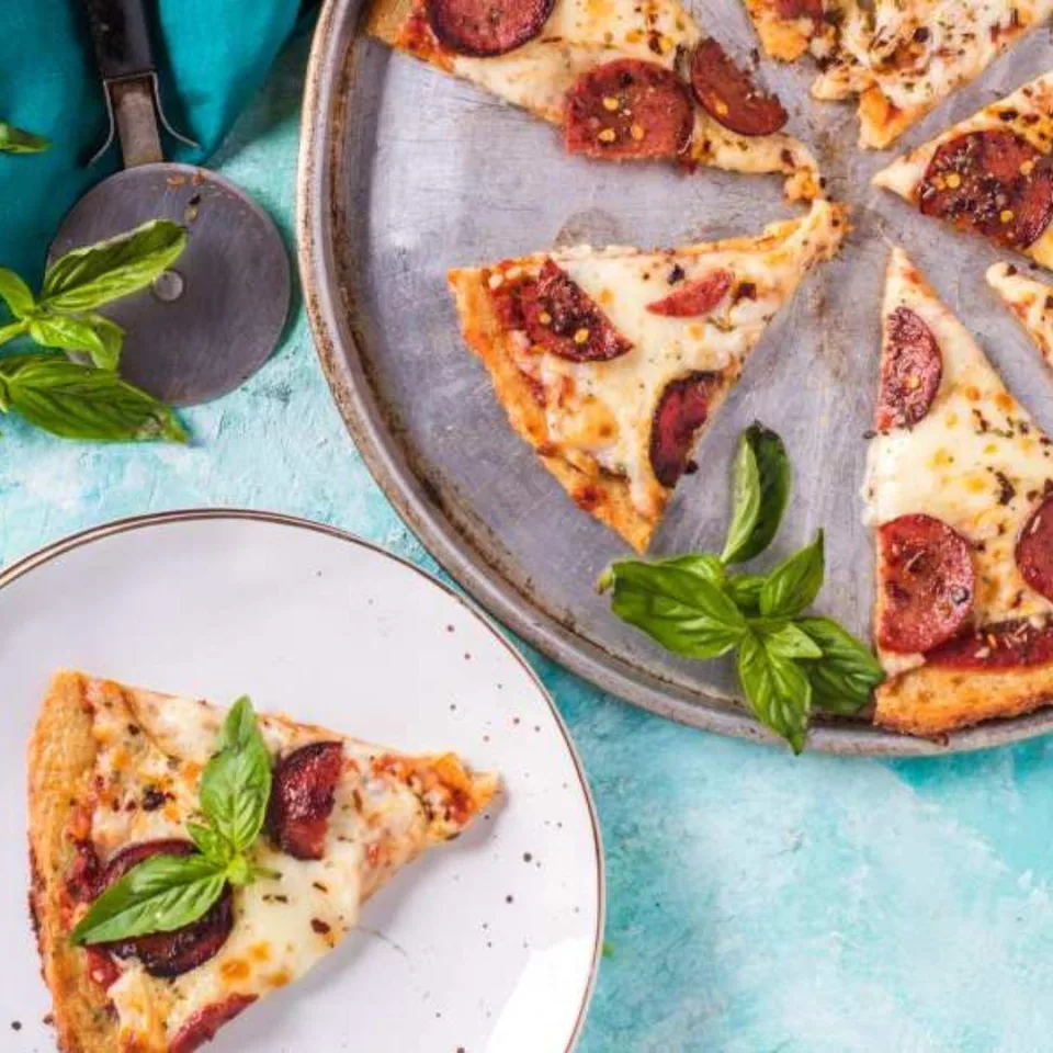 Low carb keto pizza recipe with salami tomato and basil